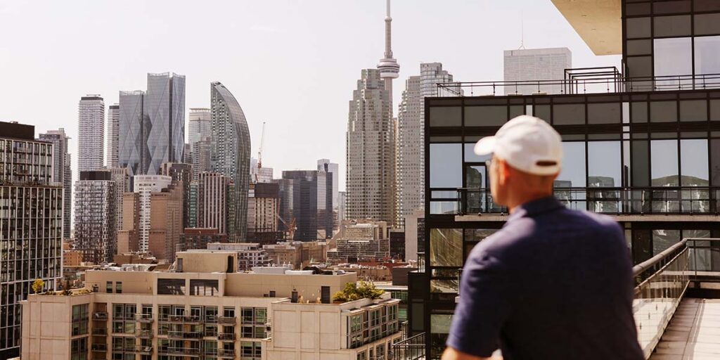 managing your first mortgage — person overlooking Toronto skyline from a condo balcony