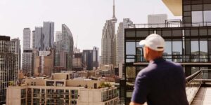 managing your first mortgage — person overlooking Toronto skyline from a condo balcony