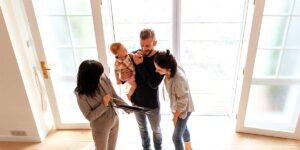 Find Housing in Canada: A real estate agent showing a home to a family.