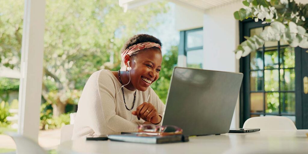 finding jobs in Canada, person using a laptop while interviewing for a job opportunity from home