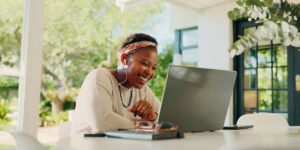 finding jobs in Canada, person using a laptop while interviewing for a job opportunity from home