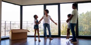 first-home buyer checklist — family standing inside a new home after moving in