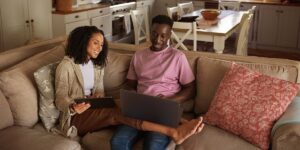 how to calculate a mortgage payment in Canada— couple using laptop at home in natural light