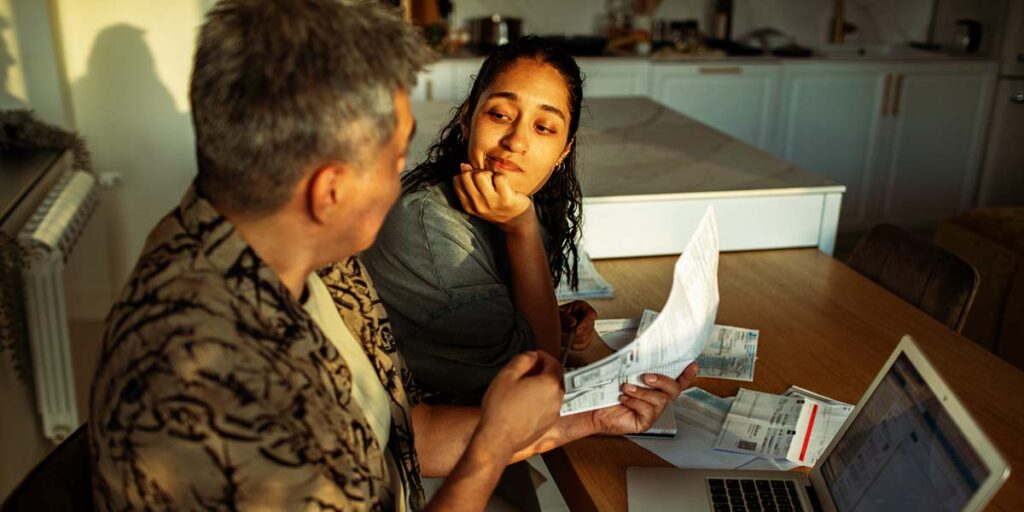 Paying down debt vs investing in Canada with father and daughter reviewing bills together