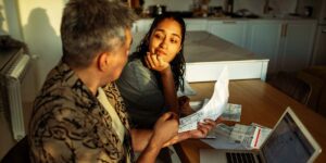 Paying down debt vs investing in Canada with father and daughter reviewing bills together