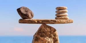 present value vs future value comparison shown using balancing stones